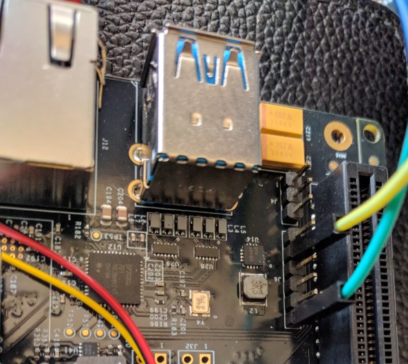 6 pin FTDI header next to PCI Express connected to serial adapter